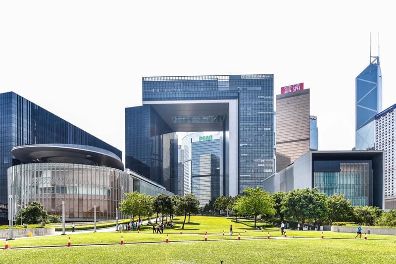 Hong Kong skyline with office towers and a lawn in the foreground.