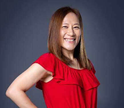 Jannet Cheung, Founder and CEO, in a red top.